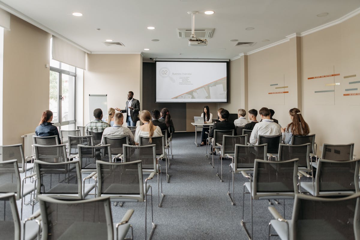 Team attending a professional business presentation in modern conference room with projector
